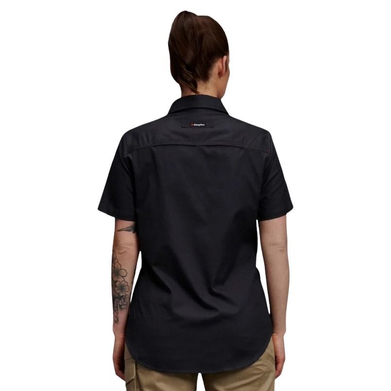 Person wearing a black short-sleeve shirt with a visible brand logo on a white background