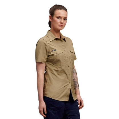 Woman wearing a beige short-sleeve shirt on a white background