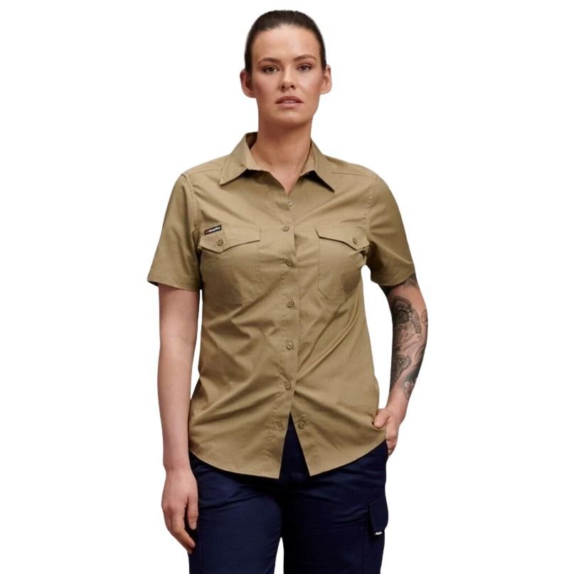 Woman wearing a beige short-sleeve shirt with a brand logo on a white background