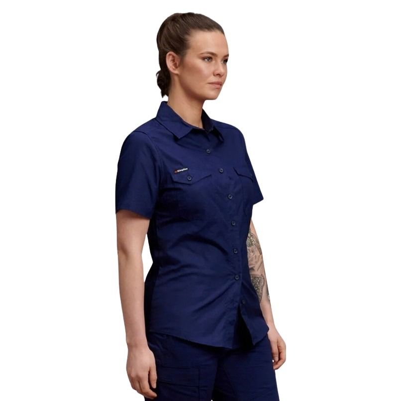 Woman wearing a navy blue shirt and pants on a white background