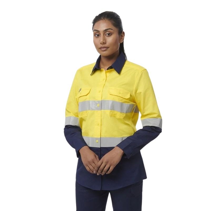 Person wearing a yellow and navy work shirt with reflective stripes on a white background
