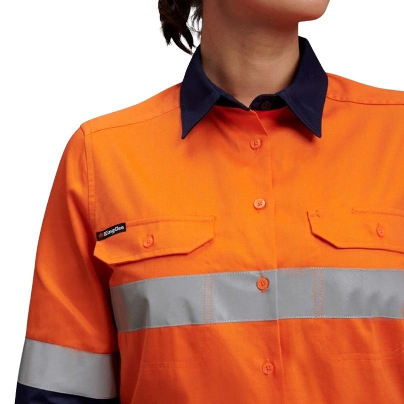 Orange work shirt with reflective stripe on a plain background