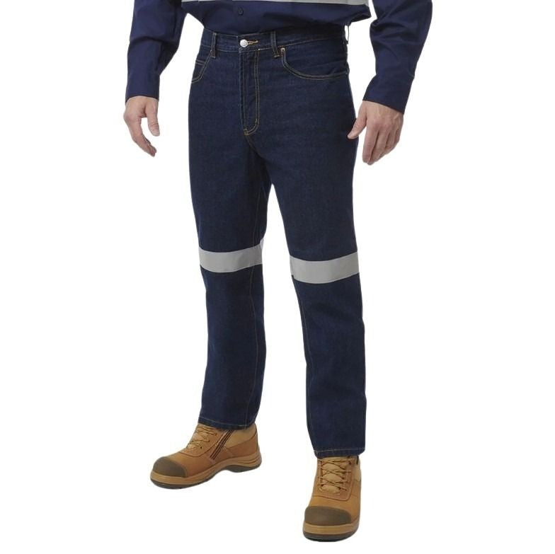 Person wearing blue jeans with reflective stripes and brown work boots on a white background