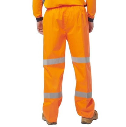Orange safety pants with reflective stripes on a white background