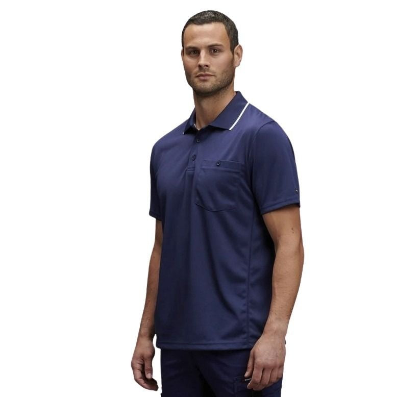 man wearing a navy polo with white edge on collar one pocket and button down on white background.