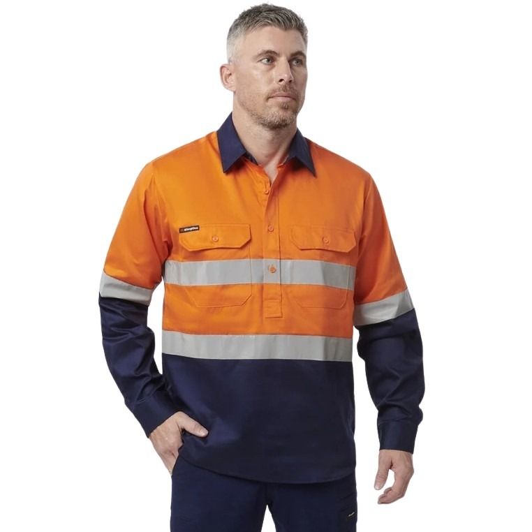 Man in orange spliced shirt with reflective tape brand name king gee on white background with two front pockets and half button placard