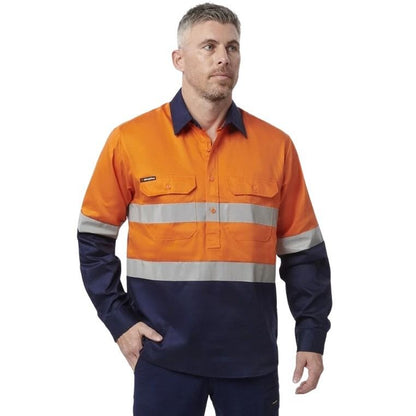 Man in orange spliced shirt with reflective tape brand name king gee on white background with two front pockets and half button placard