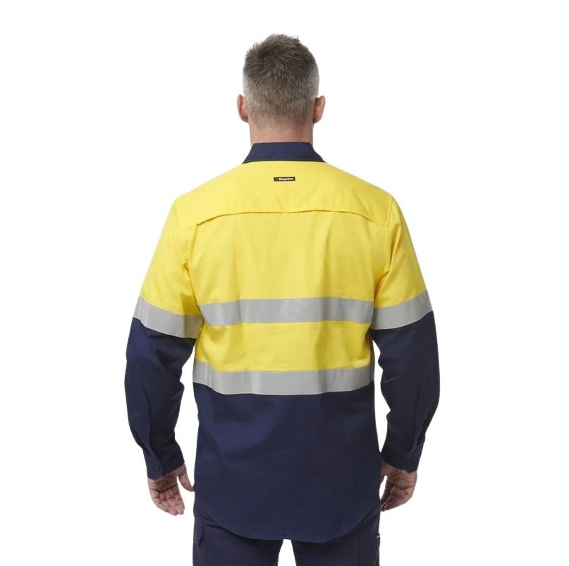 Person wearing a high-visibility work shirt with reflective stripes on a white background