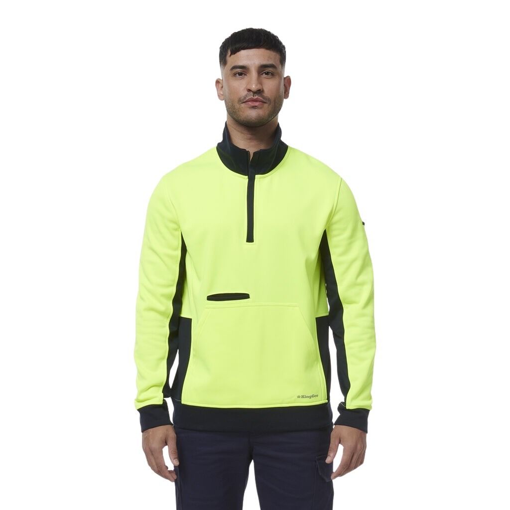 Man wearing a bright yellow and black PULLOVER on a white background