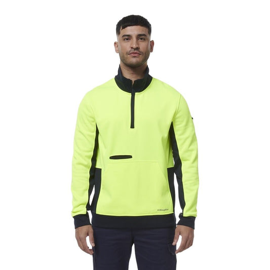 Man wearing a bright yellow and black PULLOVER on a white background