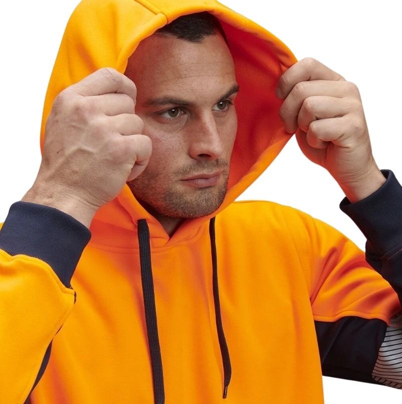Man wearing an orange hoodie with a neutral background