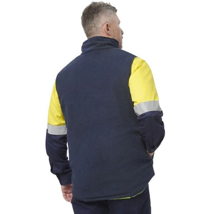 Person wearing a navy and yellow work jacket with reflective stripes on a white background