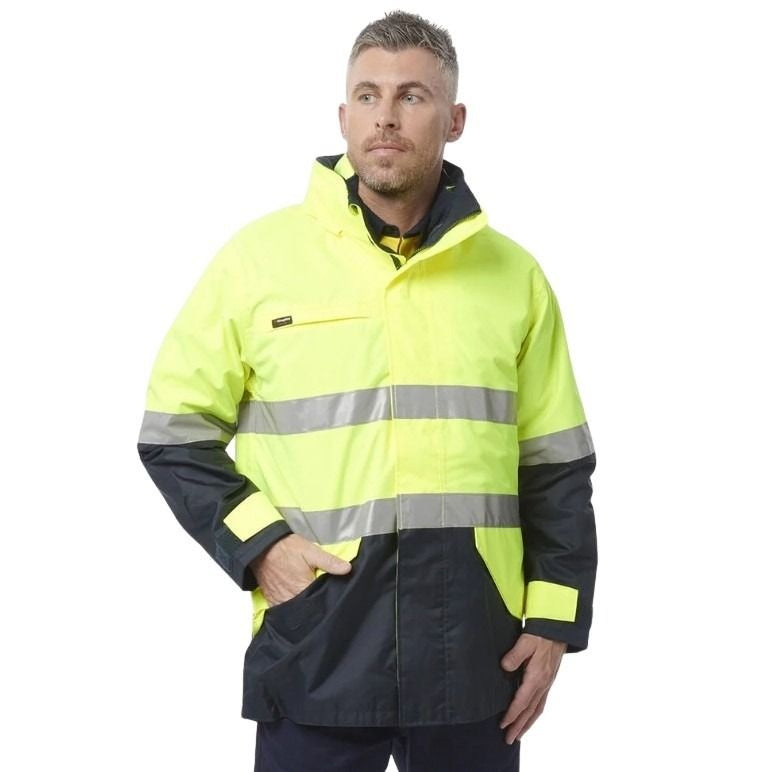 Man wearing a high-visibility jacket with reflective stripes on a white background