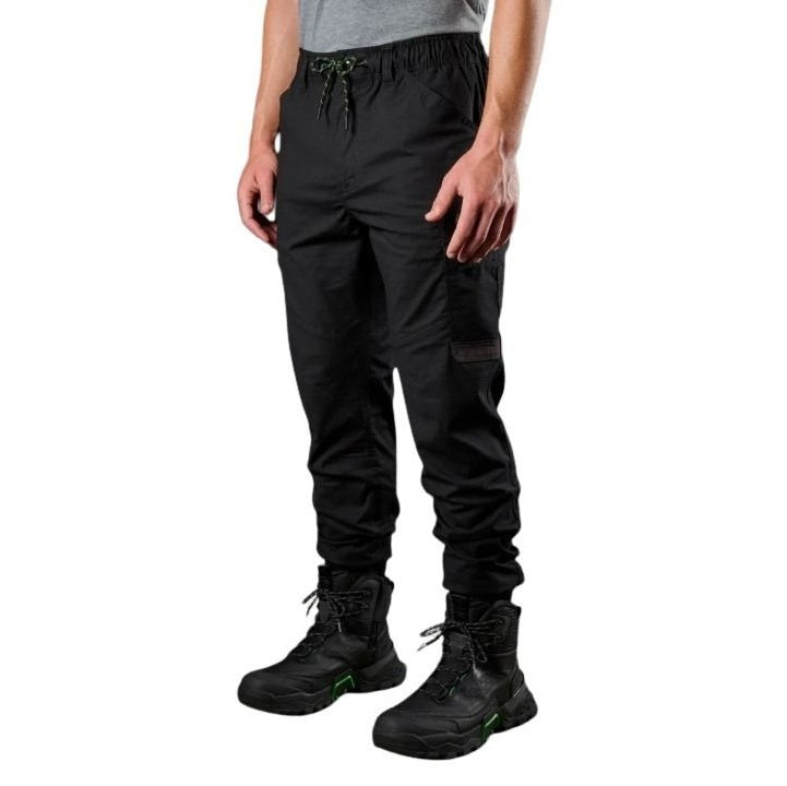 Person wearing black cargo pants and black boots on a white background