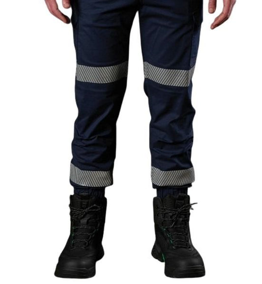 Navy work pants with reflective stripes worn by a person on a white background