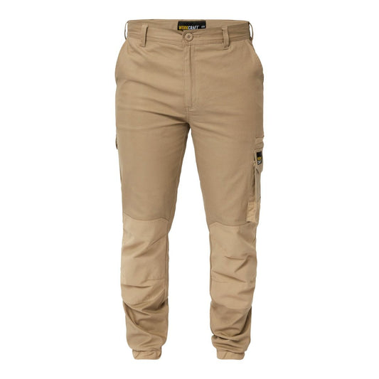 A pair of beige Workcraft WP4018 stretch cargo pants with elasticized hem, multiple pockets, and a button fly front. Khaki colour