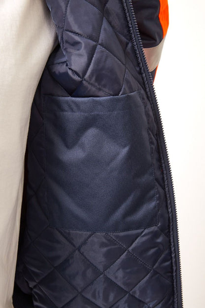 Hi-vis quilted bomber jacket inner pocket with a zipper on a light background