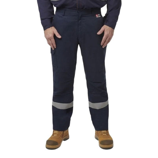 Person wearing navy work pants with reflective stripes on a white background