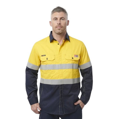 Man wearing a yellow and navy work shirt with reflective stripes on a white background
