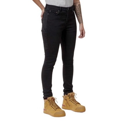 Person wearing black jeans and yellow boots on a white background