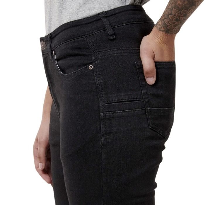 Person wearing black jeans with a white background