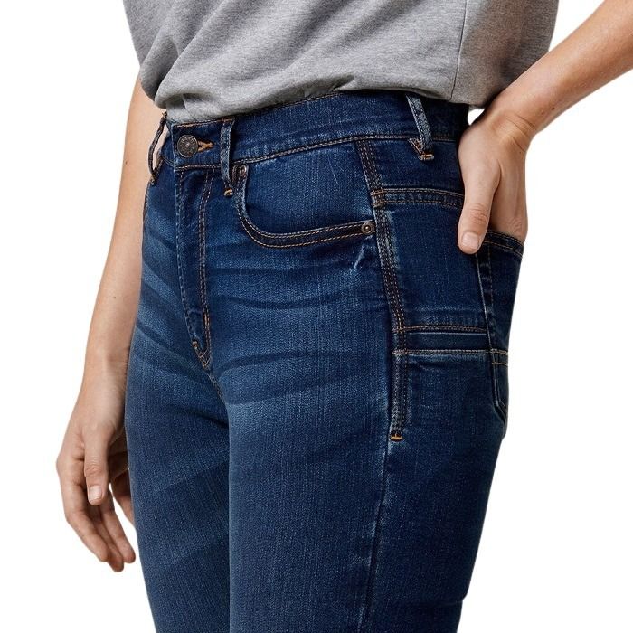Person wearing blue jeans with a gray shirt on a white background