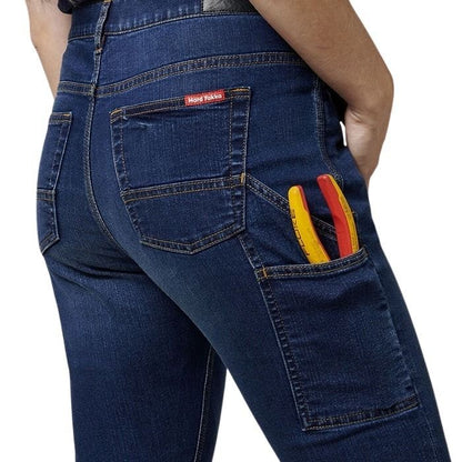 Blue jeans with a tool belt and tools in the back pocket on a white background