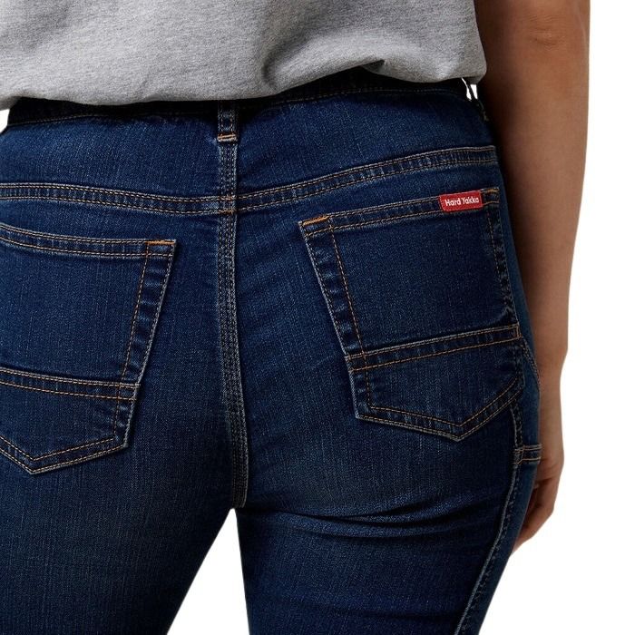 Close-up of blue jeans with a brand label on a white background