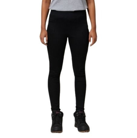 Person wearing black leggings and black boots on a white background